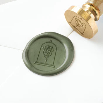 Wax seal with rose design on a white background