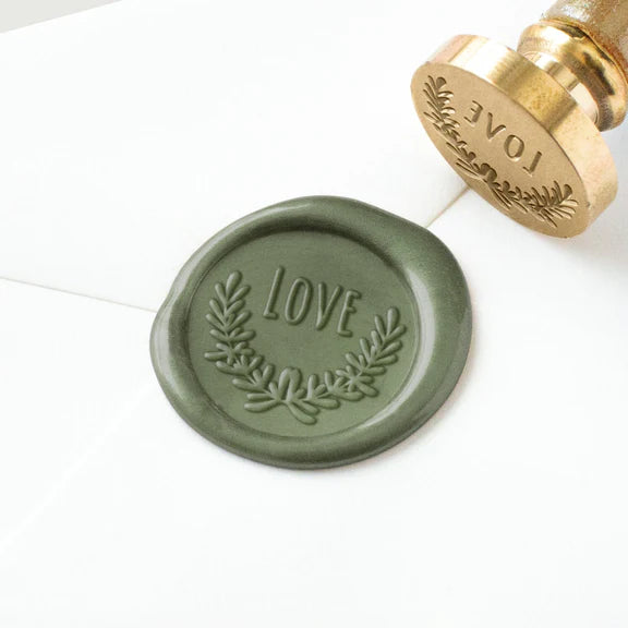 Green wax seal with 'LOVE' text